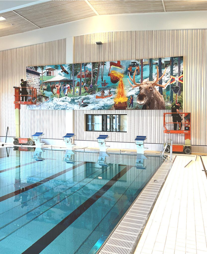 Installation of the wall illustration "Hembygd" by Marie Åhfeldt in Hällefors bathhouse, with workers mounting the artwork.