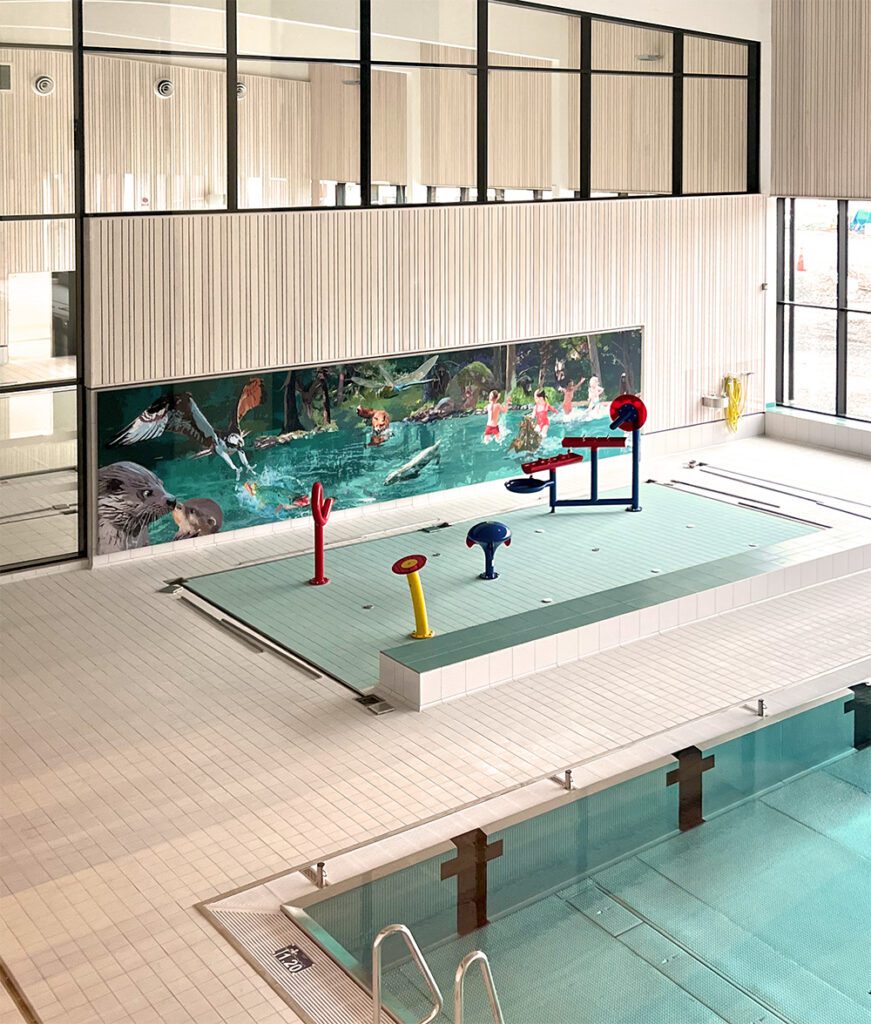 Wall illustration "Svartälven" by Marie Åhfeldt installed in the spray park area of Hällefors bathhouse, showing children, animals and water play elements.