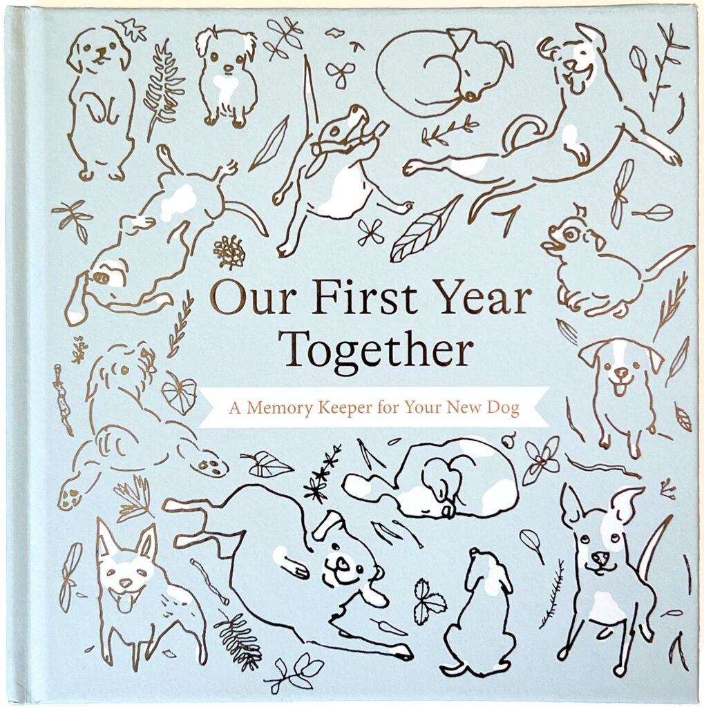 Omslag med flera glada hundar tecknade med linjer i silver som skiftar i ljuset. Runt hundarna finns kottar och blad. Bakgrunden är svagt blågrön och hundarna har inslag av vitt i pälsen.