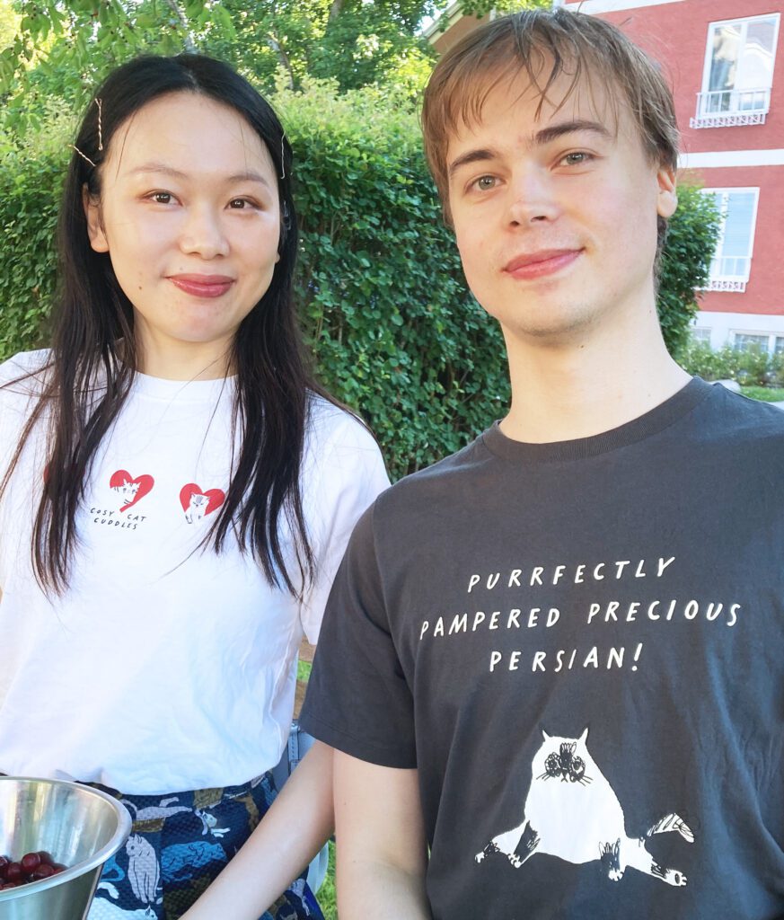 Young couple wearing “Cats are Purrfect!” Uniqlo UT T-shirts featuring illustrations by Marie Åhfeldt.